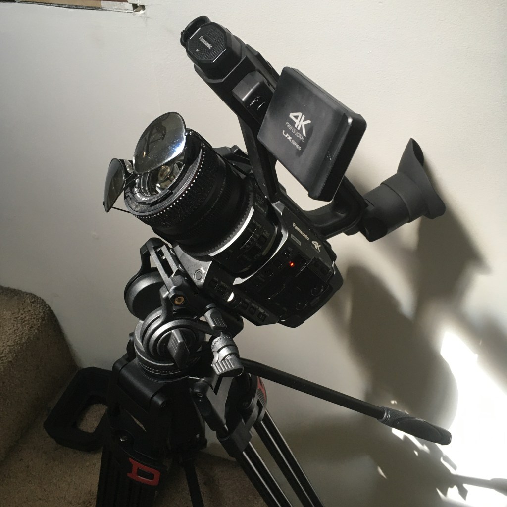 Camcorder with sunglasses in front of the lens